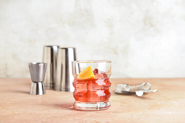 Glass of tasty Negroni cocktail on color background