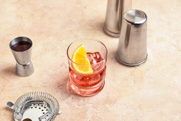Glass of tasty Negroni cocktail on color background