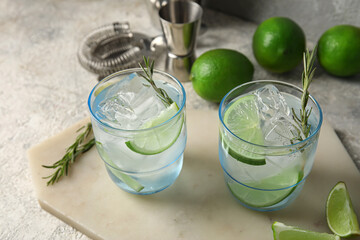 Glasses of cold gin and tonic on grunge background