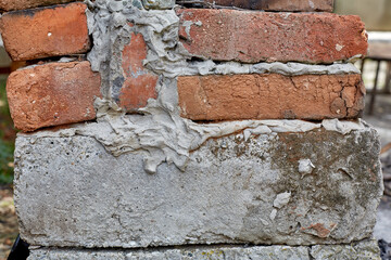 Brick and concrete wall under construction. Wall background.