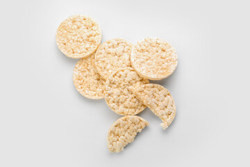 Pile of crispy rice crackers on white background