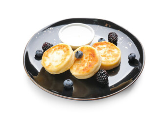 Plate with cottage cheese pancakes on white background