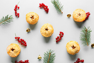 Composition with Christmas mince pies, cranberry and fir branches on white background © Pixel-Shot
