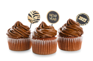 Tasty cupcakes for New Year 2022 celebration on white background