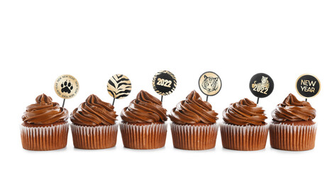 Tasty cupcakes for New Year 2022 celebration on white background