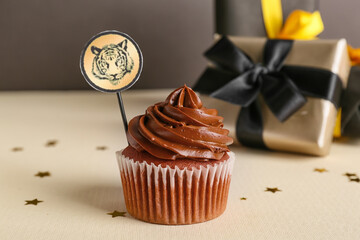 Tasty cupcake for New Year 2022 celebration on table