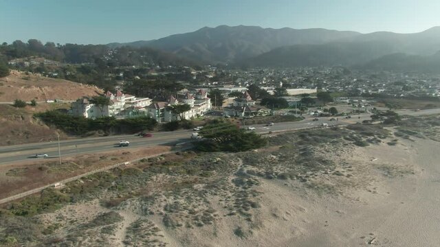 Aerial: Traffic along the beach town of Pacifica, California, USA