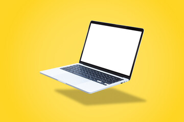 Laptop computer with blank screen, floating on a yellow background.