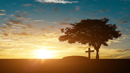 Silhouette of grave and christian cross at sunset sky background. Halloween day concept.
