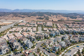 Aerial view of a modern upscale suburban neighborhood with single family homes on a clear day