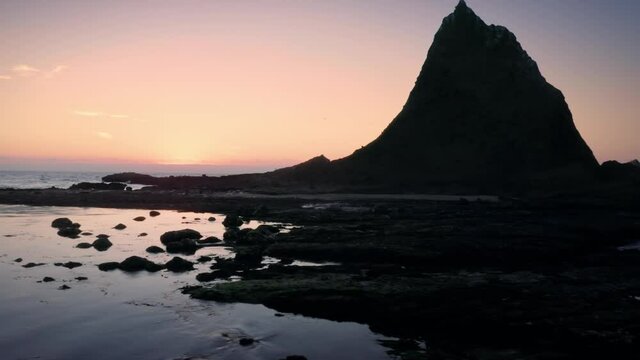 Aerial: Shark Fin rock at sunset on Martin's Beach, California, USA