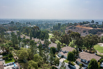 Fototapeta na wymiar Aerial View of a Suburban California Community Near a Golf Course on a Foggy Day