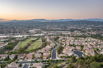 Aerial view of a gorgeous southern California sunset from an upscale neighborhood on a golf course. 
