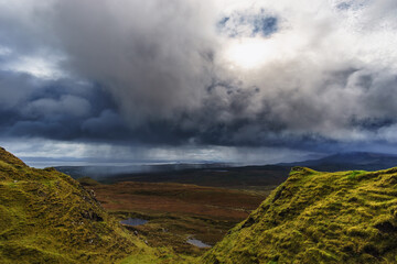 Beautiful landscape with falling rain on green grass and lakes, Isle of Skye, Scotland