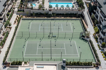 Aerial view of tennis courts and an upscale resort pool.