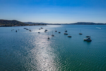 Waterscape with boats and sunlight path on the water