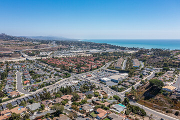 Fototapeta premium Shopping center aerial view. Southern California community near the ocean