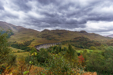 Fototapeta na wymiar scottish landscape with Glenfinnan Viaduct and cloudy sky, Scotland