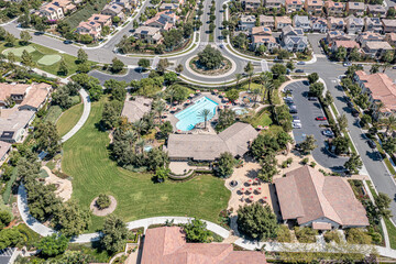 Aerial view of roundabout, pool, park, and clubhouse for a master planned community in Southern California.
