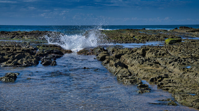 A Wave Splashing in Over the Rocks at The Entrance