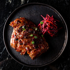 Toskana steak with pink grated beetroot and carrot salad, top view on marble background