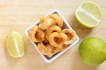 Pork cracklings, appetizer on wooden table.