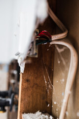 laundry room renovation with plaser walls interior exposed with visible electricity wires, home renovations and tradesman work
