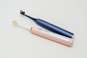 two modern ultrasonic toothbrushes on a white background. Oral hygiene.