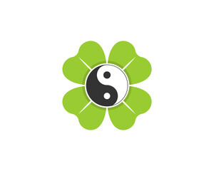 Yin and yang symbol with clover leaf behind