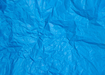 Crumpled blue paper abstract background texture