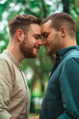 gay couple looking at each other on the park