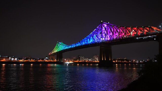 Jacques Cartier Bridge in a rainbow lighting at night. Montreal, Quebec, Canada.