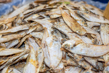 A pile of salty dried sea fish close up view on a market with selective focus