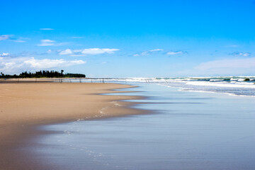 Beautiful landscape view of empty sea beach under the bright blue sky