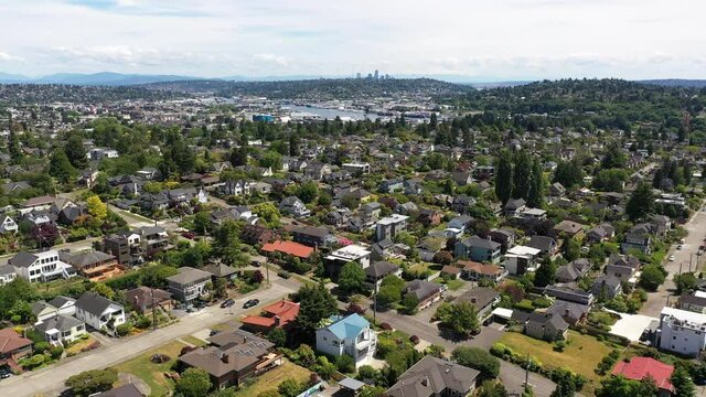 Cinematic 4K aerial drone dolly out footage of Sunset Hill, Loyal Heights, Adams, Lawtonwood, Ballard Bridge, near Ballard, Seattle, by Puget Sound