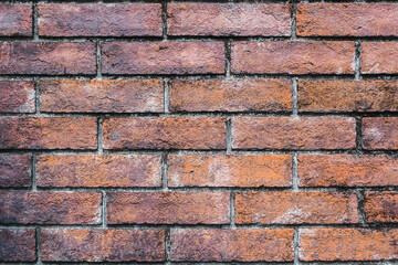 The textures of the red orange old brick blocks as the wall