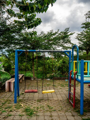Fototapeta na wymiar children's swing in a deserted playground due to the covid pandemic 