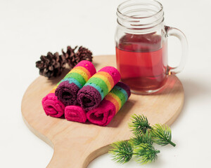 Sponge rolls consist of several colors forming a rainbow formation. Start your morning with a piece of sponge and warm tea. Sponge with a sweet taste and soft texture. Focus blur. Rainbow cake mockup.