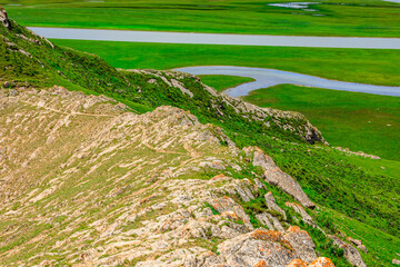 Green grassland and mountain natural landscape in Xinjiang,China.
