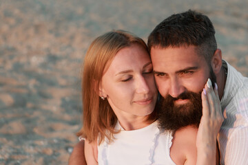 Fototapeta premium a guy and a girl on the sea. Couple love in water. people on the beach