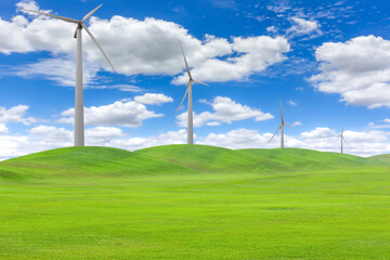 Wind turbines in a field of green grass