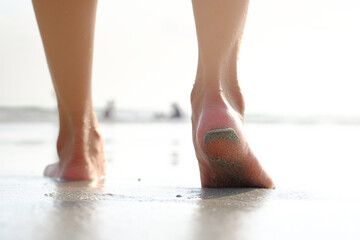 Asian tourist female legs She was walking on a beautiful sandy beach. and she was about to walk...