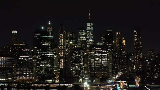 Drone Night Shot Of The New York City Manhattan Skyline, Freedom Tower and Hudson River, Shot From Brooklyn