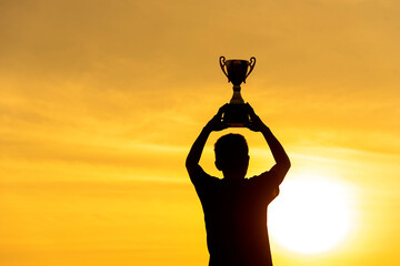 Winner win hands holding golden champion trophy cup prize. Silhouette best award victory hands...