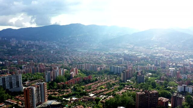 Drone Shot of the city of Medell&iacute;n, Colombia showing mountains and the city on a sunny cloudy afternoon.