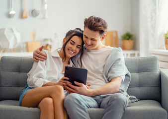 Obraz premium couple having fun and hugging at home.