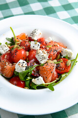 Tomato and salmon salad with cheese and spices. Traditional Italian cuisine, Italian concept.