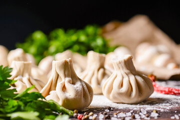 Georgian dumpling or Khinkali. Georgian homemade khinkali on wooden background.