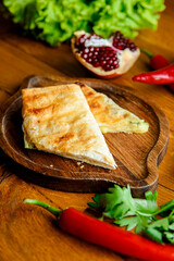 Homemade lavash bread with vegetables, spinach and lettuce on old wooden background.