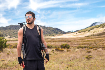 hiker man wearing sunglasses in the warm savanna of Chirripo National Park in Costa Rica